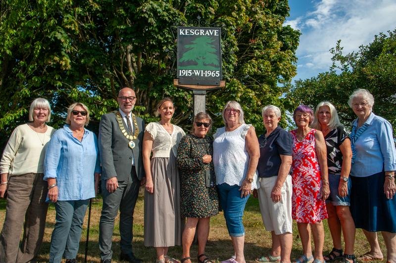 Members of the Kesgrave Women’s Institute and Town Council standing beside the restored Kesgrave Town Sign on Bell Lane, marking its 60th anniversary.