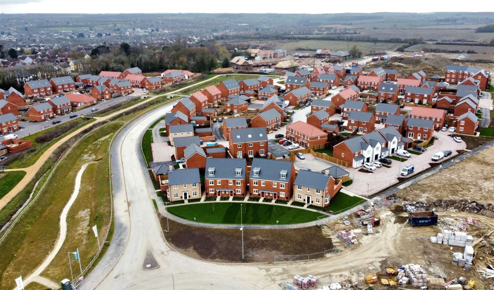 Aerial view of new red-brick homes and the developing A143 road layout on the edge of Haverhill, showing how Suffolk’s landscape is changing with housing expansion.