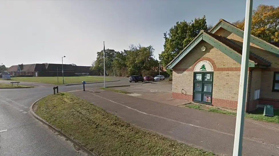 Exterior view of Kesgrave Town Council Office on Ropes Drive, with the car park and nearby Tesco store visible in the background.